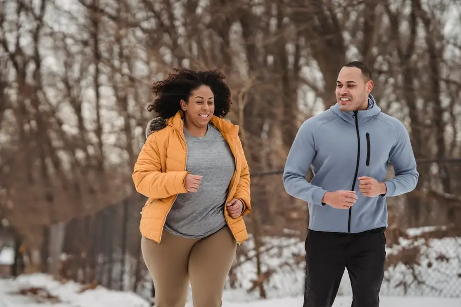 Two adults jogging in a winter park, expressing vitality and fitness.